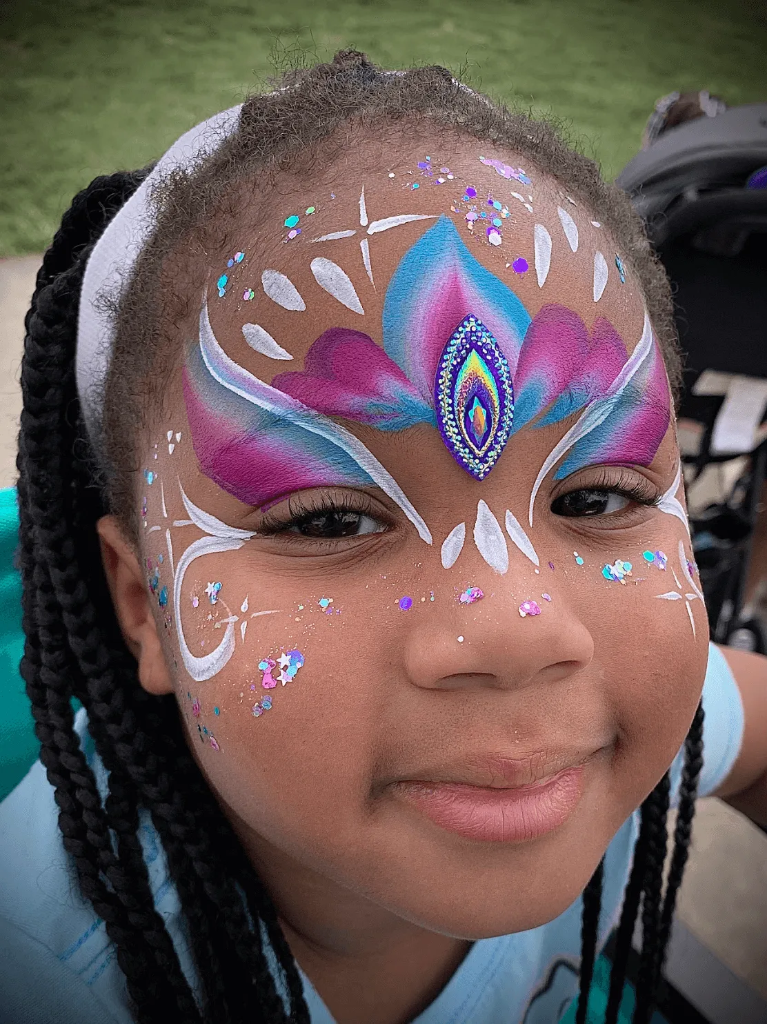 A kid proudly displaying an amazing facepaint artwork