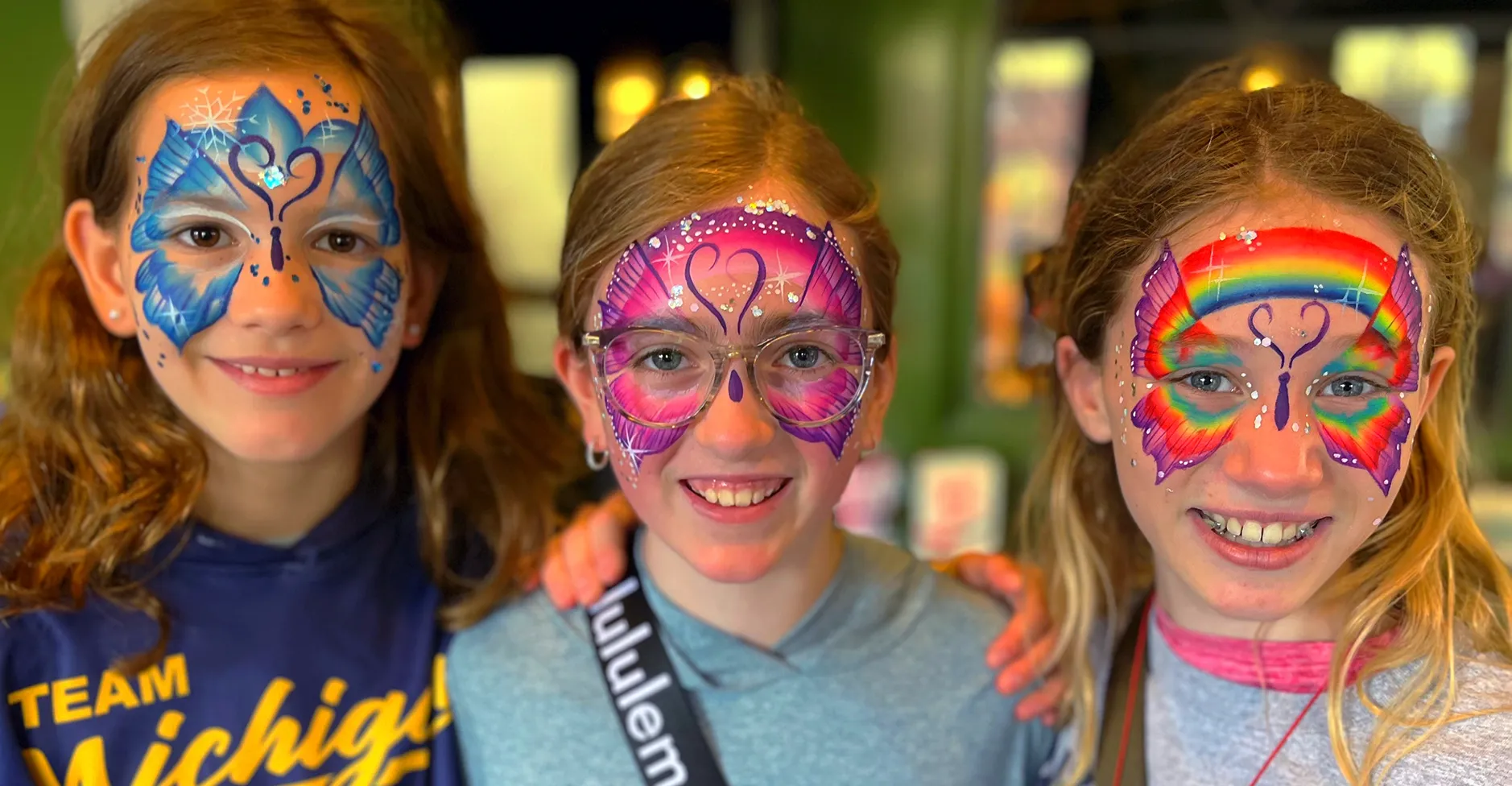 A kid proudly displaying an amazing facepaint artwork