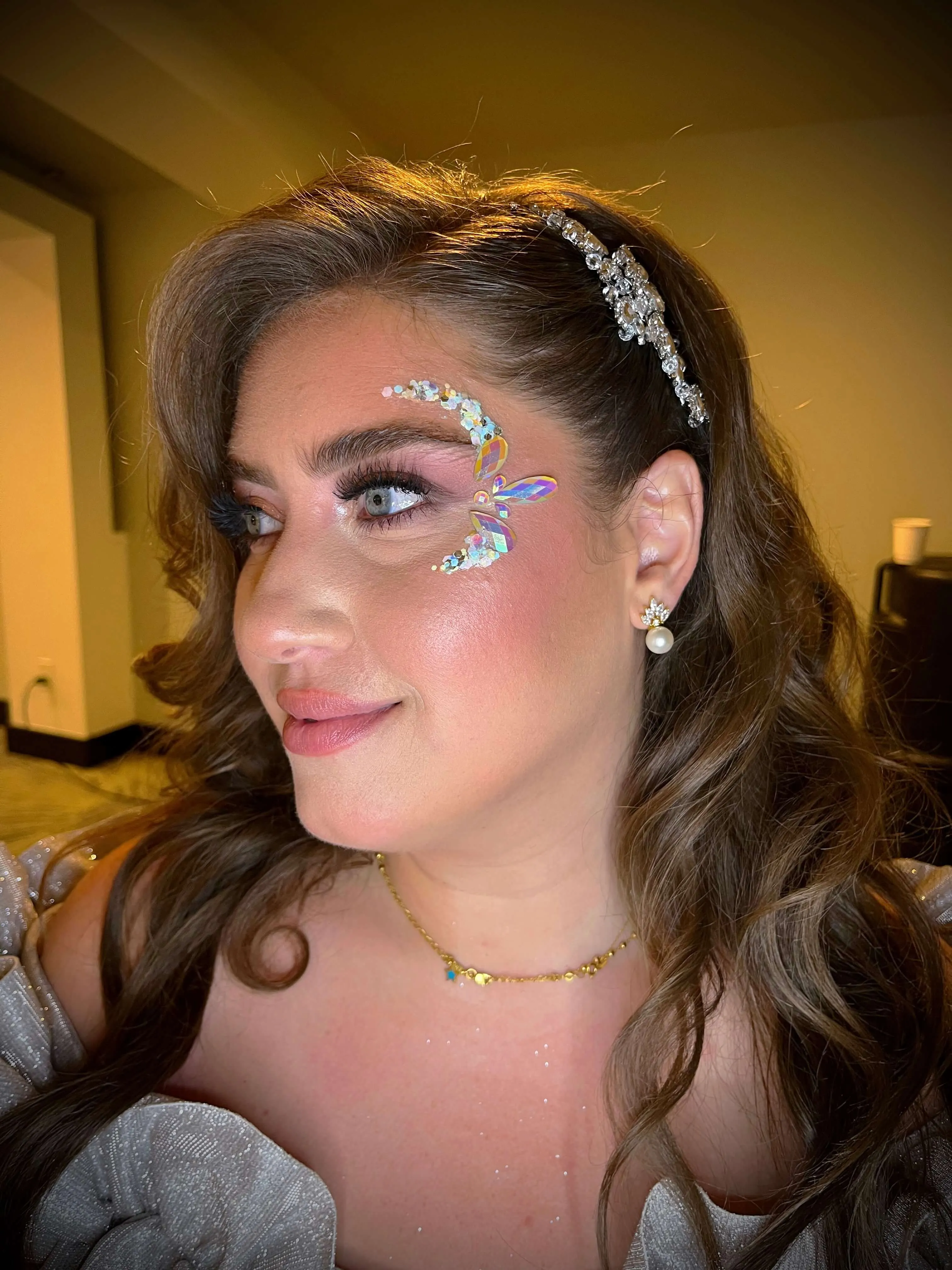 A beautiful face adorned by intricate glitter art